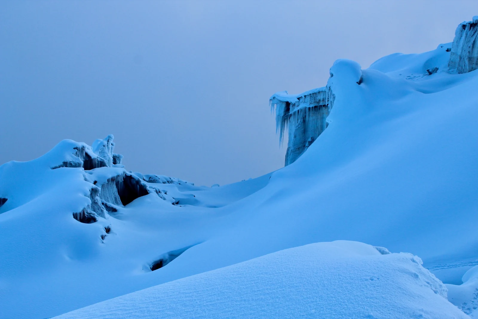 Blue snow, hollows and overhanging ice on the glacier of Cotopaxi.