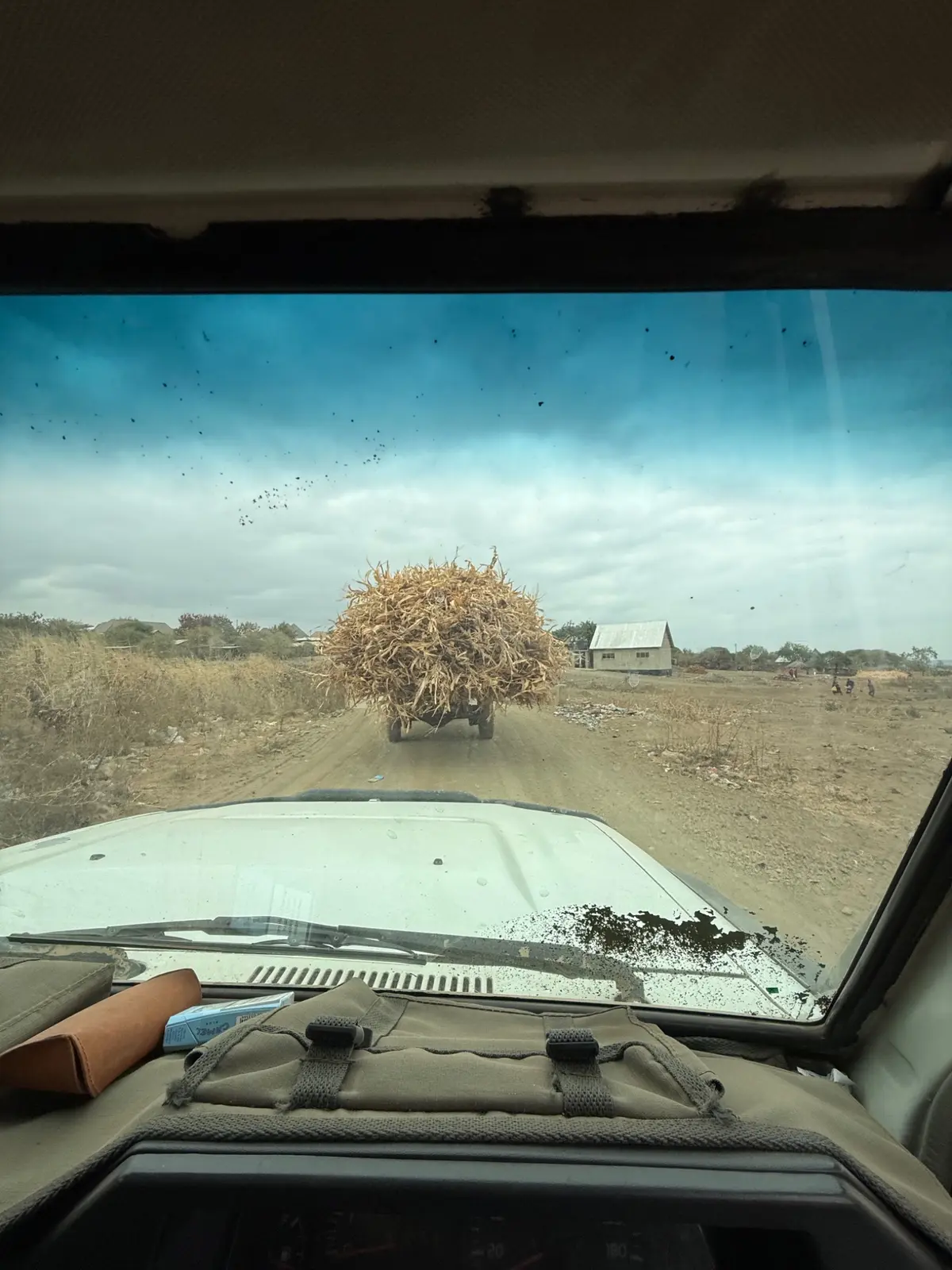 A track seen through a vehicle windscreen with the bonnet in the foreground.